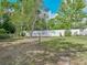 Expansive backyard featuring a clothesline and bordered by a privacy fence and mature trees at 407 Ne 8Th St, Mulberry, FL 33860