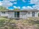 Siding on back of home with sliding doors, windows, and side entry door at 407 Ne 8Th St, Mulberry, FL 33860