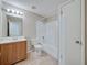 Bathroom featuring a vanity with wood cabinets, a toilet, and a shower-tub combination at 407 Ne 8Th St, Mulberry, FL 33860