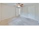 Simple bedroom has carpet and ceiling fan with easy access to other rooms at 407 Ne 8Th St, Mulberry, FL 33860