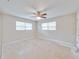Bedroom featuring a ceiling fan and natural light from the large windows at 407 Ne 8Th St, Mulberry, FL 33860