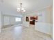 An open dining room shows the open view to the kitchen and features tile floors and a chandelier at 407 Ne 8Th St, Mulberry, FL 33860