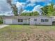 Charming single-story home with a front yard, garage, and a driveway on a sunny day at 407 Ne 8Th St, Mulberry, FL 33860