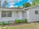 Exterior view of a home's front door, plants, and a window at 407 Ne 8Th St, Mulberry, FL 33860