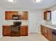 Well-lit kitchen with modern appliances, dark wood cabinets and plenty of counter space at 407 Ne 8Th St, Mulberry, FL 33860