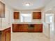 Kitchen featuring dark cabinets, black appliances, and a view into the living spaces at 407 Ne 8Th St, Mulberry, FL 33860