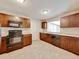 Kitchen showcasing dark cabinets, black appliances, sink, and a view to the backyard at 407 Ne 8Th St, Mulberry, FL 33860