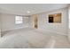 A comfortable living room offers plush carpeting, neutral paint, and a view to the kitchen at 407 Ne 8Th St, Mulberry, FL 33860