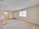 A large living room features neutral paint, tile floors, and an exterior door at 407 Ne 8Th St, Mulberry, FL 33860