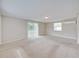 An airy living room offers plush carpeting, neutral paint, a sliding glass door and plenty of light at 407 Ne 8Th St, Mulberry, FL 33860