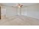 Main bedroom featuring carpet floors, double closets, and an ensuite bathroom at 407 Ne 8Th St, Mulberry, FL 33860