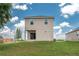A spacious backyard featuring a covered patio, a well-maintained lawn and a freshly planted tree at 4189 Radford Rd, Bartow, FL 33830
