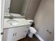 Half bathroom featuring a granite countertop, white vanity, modern fixtures and a toilet at 4189 Radford Rd, Bartow, FL 33830