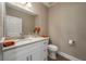 Powder room featuring granite vanity and wood floor at 4189 Radford Rd, Bartow, FL 33830
