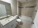 Bathroom with a shower/tub combo with decorative tile, granite vanity, and neutral wall paint at 4189 Radford Rd, Bartow, FL 33830