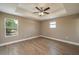 Bright bedroom featuring wood floors, a ceiling fan, and natural light at 4189 Radford Rd, Bartow, FL 33830