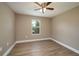 Bright bedroom featuring wood-look floors, a ceiling fan, and neutral paint at 4189 Radford Rd, Bartow, FL 33830