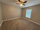 Bedroom features neutral walls, carpet flooring, a ceiling fan, and a window at 4189 Radford Rd, Bartow, FL 33830