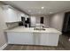 Bright kitchen featuring white cabinets, granite countertops, stainless steel appliances, and wood-look flooring at 4189 Radford Rd, Bartow, FL 33830