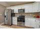 Well-lit kitchen with stainless steel appliances and white cabinets at 4189 Radford Rd, Bartow, FL 33830