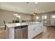 Open-concept kitchen with stainless appliances, granite countertops and adjoins the dining and living areas at 4189 Radford Rd, Bartow, FL 33830
