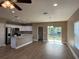 Open concept kitchen with stainless steel appliances, center island, and sliding glass doors to the backyard at 4189 Radford Rd, Bartow, FL 33830