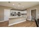 Bright kitchen featuring a granite-topped island, modern white cabinets, and stainless steel appliances at 4189 Radford Rd, Bartow, FL 33830