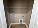 Laundry room area with hookups, laminate flooring, neutral paint, and wire shelving at 4189 Radford Rd, Bartow, FL 33830