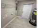Laundry room with tile flooring, door to outside, water heater, and a utility sink at 4189 Radford Rd, Bartow, FL 33830
