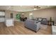 Open-concept living area with wood-look flooring, comfortable seating, and ample natural light at 4189 Radford Rd, Bartow, FL 33830