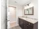 Bathroom featuring granite counters, dark cabinets, rectangular framed mirror and modern lighting at 4215 Sunnyside Dr, Lakeland, FL 33810