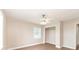 Bedroom features new floors, a ceiling fan, a window, and a closet with a clothes rack at 4215 Sunnyside Dr, Lakeland, FL 33810