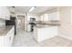 Updated kitchen featuring white cabinetry, granite countertops, and stainless steel appliances at 4215 Sunnyside Dr, Lakeland, FL 33810