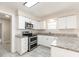 Well-lit kitchen boasts white cabinets, modern appliances, and ample counter space at 4215 Sunnyside Dr, Lakeland, FL 33810