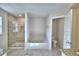 Bathroom with a tiled shower, soaking tub, and separate toilet room for added privacy at 4318 Juliana Lake Dr, Auburndale, FL 33823