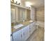 Bathroom featuring a double vanity with granite counters and tiled shower-tub combination at 4318 Juliana Lake Dr, Auburndale, FL 33823