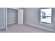 Cozy bedroom with plush carpet, closet, and large window providing natural light at 4318 Juliana Lake Dr, Auburndale, FL 33823