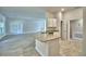 Open kitchen featuring granite countertops, white cabinets, and a view to the living room at 4318 Juliana Lake Dr, Auburndale, FL 33823