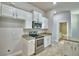 Modern kitchen featuring stainless steel appliances, granite countertops, and white cabinets with modern hardware at 4318 Juliana Lake Dr, Auburndale, FL 33823