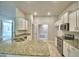 Modern kitchen featuring white cabinets, granite countertops, and stainless steel appliances at 4318 Juliana Lake Dr, Auburndale, FL 33823