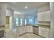 Open kitchen featuring granite countertops, white cabinetry, and a breakfast bar, perfect for gatherings at 4318 Juliana Lake Dr, Auburndale, FL 33823