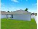 The backyard features a well-maintained lawn with a clean white fence at 4412 Reding Way, Lakeland, FL 33813