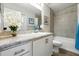 Bright bathroom with a tub and shower combination and a granite vanity at 4412 Reding Way, Lakeland, FL 33813
