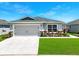 Charming single-story home with a well-maintained lawn and a two-car garage at 4412 Reding Way, Lakeland, FL 33813
