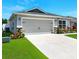 Charming home exterior showcases a well-manicured lawn and a two-car garage at 4412 Reding Way, Lakeland, FL 33813