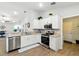 Well-lit kitchen featuring stainless steel appliances, white cabinetry and granite countertops at 4412 Reding Way, Lakeland, FL 33813