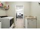 View from laundry area into dining area shows continuous flooring and convenient flow at 4412 Reding Way, Lakeland, FL 33813