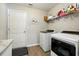 Efficient laundry room with a washer, dryer, storage shelf, and well-lit space at 4412 Reding Way, Lakeland, FL 33813