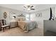 Cozy main bedroom with plush carpet, a decorative headboard and a ceiling fan at 4412 Reding Way, Lakeland, FL 33813