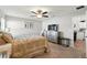 Cozy main bedroom with plush carpet, a ceiling fan and dresser with television at 4412 Reding Way, Lakeland, FL 33813
